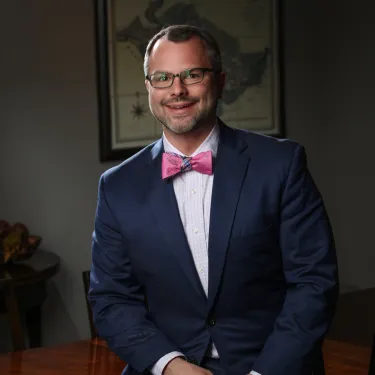 a man in a suit and bow tie