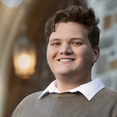 Young Man in Brown Sweater Smiling