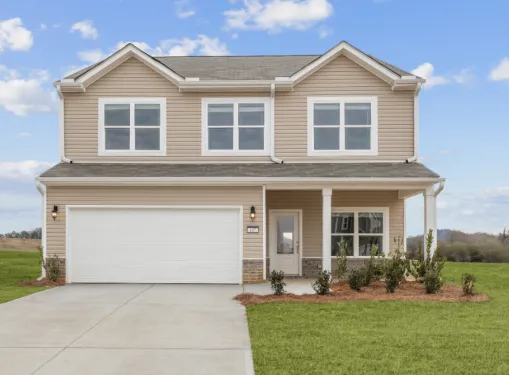 Two-story beige house with white trim, double garage, front porch, and green lawn under a blue sky.