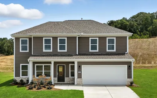 Two-story modern house with gray siding, white trim, front porch, and attached two-car garage on clear day.