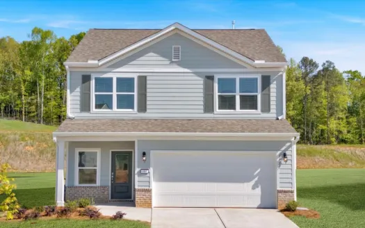 Beautiful two-story house with gray siding and a spacious yard surrounded by trees.