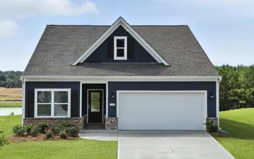 Modern blue house with white trim, large garage door, front porch, and well-maintained green lawn under clear sky