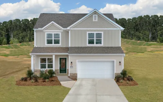 Two-story modern suburban house with gray siding, white garage door, and landscaped front yard under blue sky.