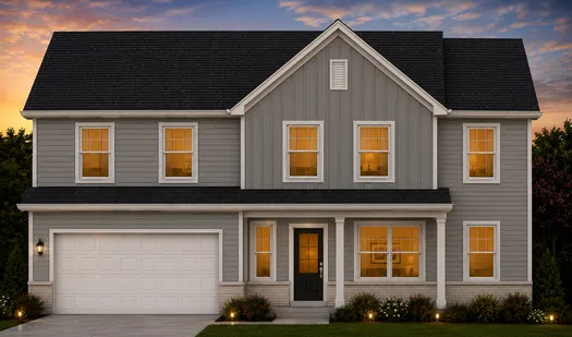 Two-story gray suburban house with white trim, black roof, illuminated windows, and front porch at sunset.