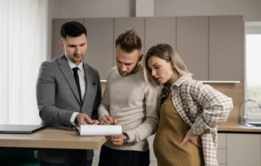 a group of people looking at a paper