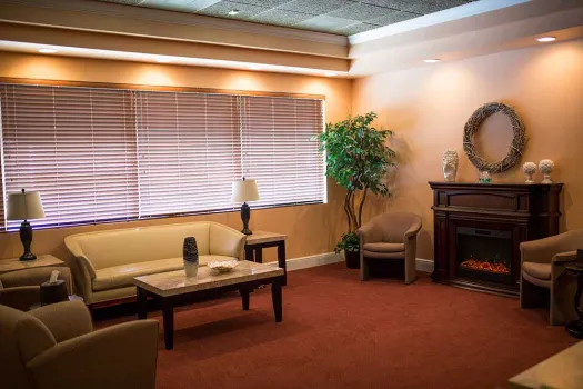 a living room filled with furniture and a large window