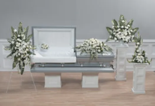 a room filled with furniture and vase of flowers on a table