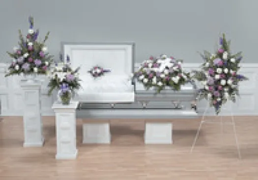 a room filled with furniture and vase of flowers on a table