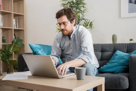 a man doing work on his laptop
