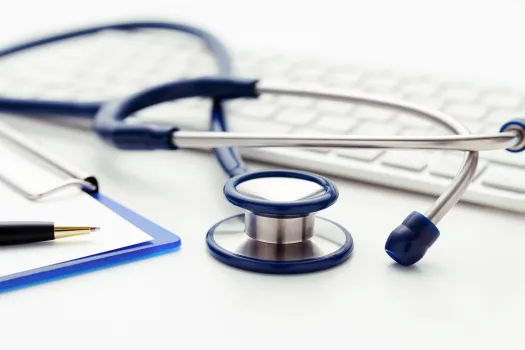 a stethoscope next to a computer keyboard
