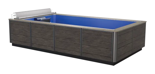 Rectangular above-ground pool with dark wood paneling and blue water interior and cover roller.