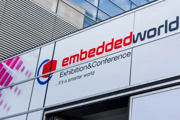 Signage for embedded world Exhibition & Conference with logo and slogan on building exterior.