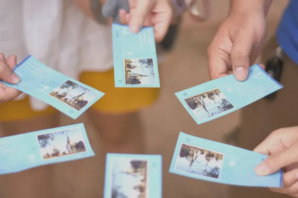 a group of people holding cards