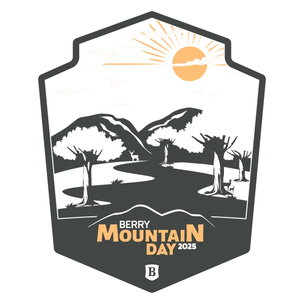 Badge-style illustration of mountain landscape with trees, deer, birds, sun, and text Berry Mountain Day 2025.