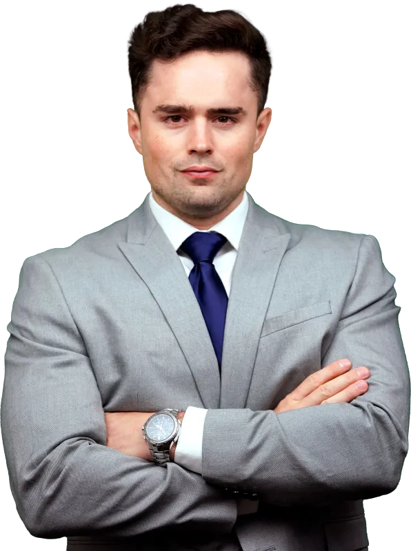 Confident young man in gray suit with blue tie, arms crossed and wearing a silver wristwatch.