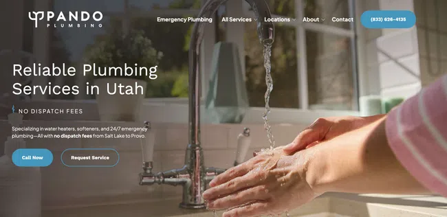 Person washing hands under running kitchen faucet highlighting reliable plumbing services in Utah.