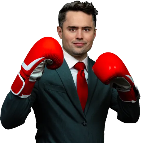 a man wearing a suit and red tie with boxing gloves