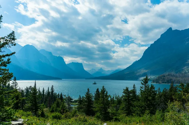 a lake surrounded by trees and mountains