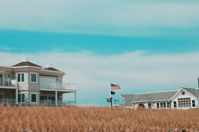 a row of houses with a flag on the roof