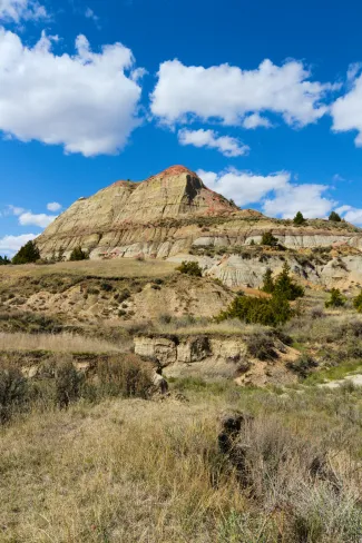 a rocky mountain with a blue sky