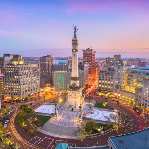 Aerial view of Indianapolis Monument Circle at sunset, highlighting the monument and city skyline.