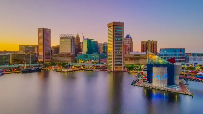 a city skyline with a body of water in the foreground