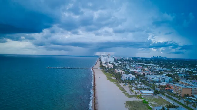 a beach with buildings and water