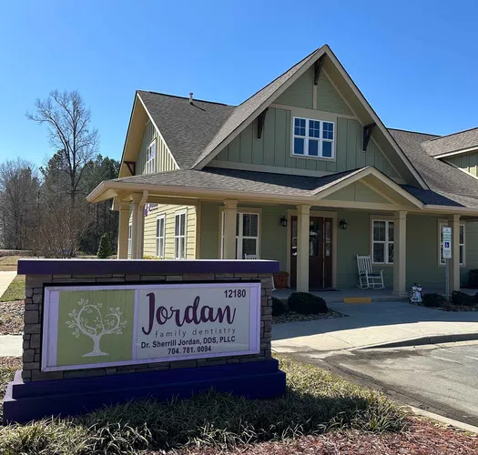 Jordan Family Dentistry office building with a sign displaying Dr. Sherrill Jordan and contact number 704-781-0094.