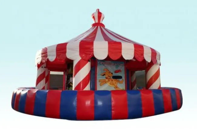 Red and white striped inflatable carousel with blue and red base and dog graphic on entrance panel.