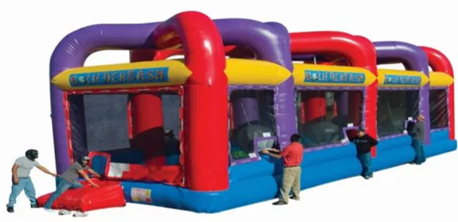 Large colorful inflatable bumper car ride with children pushing and playing on white background