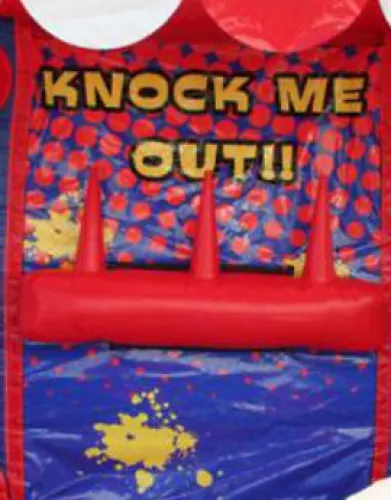 Colorful inflatable game with red spikes and text saying Knock Me Out on a blue and red background