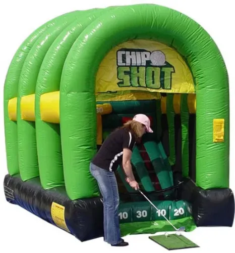 Woman playing golf putting game on green inflatable Chip Shot amusement attraction with point targets.