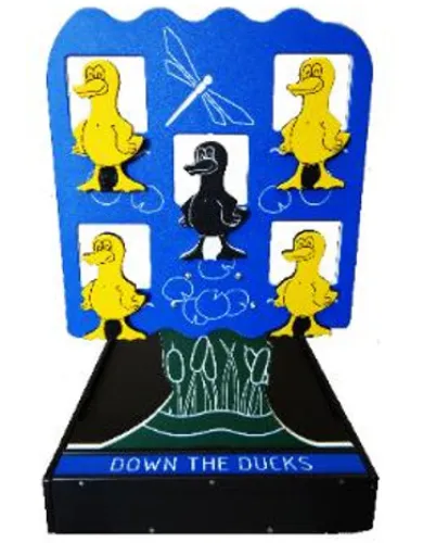 Carnival game 'Down the Ducks' featuring five yellow ducks and one black duck on a blue background with a dragonfly.