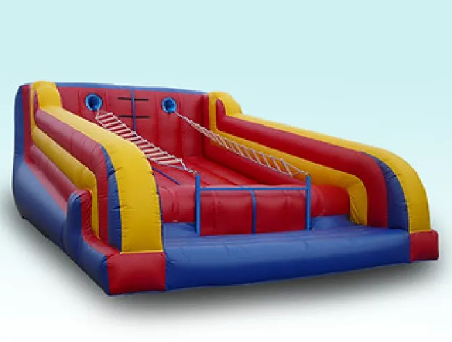 Inflatable red, yellow, and blue climbing obstacle course with rope ladders and safety barriers on a white background