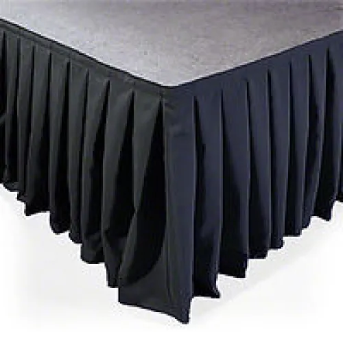 Black pleated table skirt covering the edge of a rectangular table with a fabric-covered top.