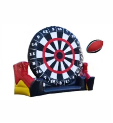 Inflatable giant dartboard with large football used as a dart in a sporty outdoor game setup.