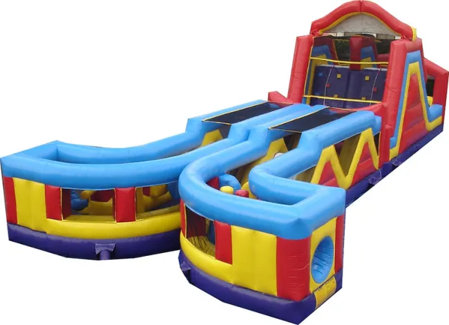 Colorful inflatable obstacle course with slides and tunnels in red, blue, yellow, and purple on white background.