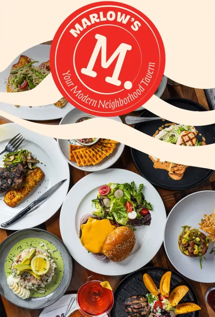 Overhead view of diverse plated dishes including burger, steak, salad, and drinks at Marlow's neighborhood tavern.