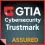 GTIA Cybersecurity Trustmark logo with assured status in bold on dark background with red border.