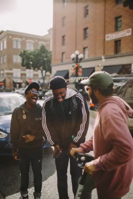 a group of men standing on a sidewalk