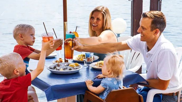 a group of people sitting at a table eating food