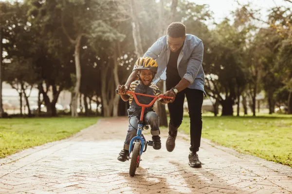 Split Custody - Dad Playing with son riding a bike