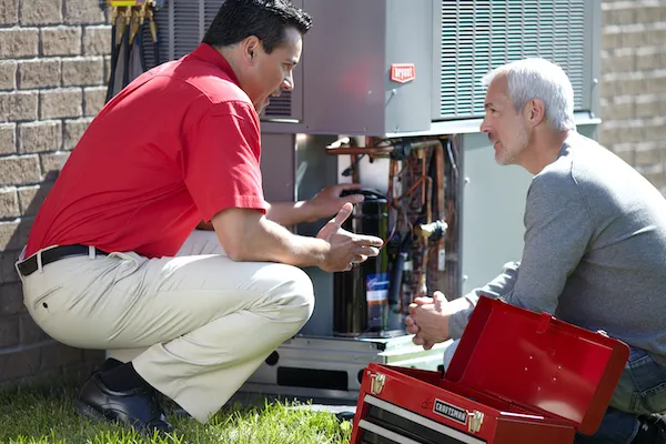 HVAC Technician explaining AC system to client