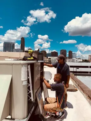 a man and a boy working on a truck