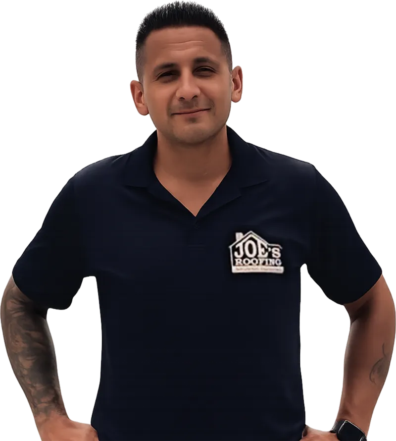 Smiling man wearing a navy blue Joe's Roofing polo shirt with tattooed arms and short black hair.