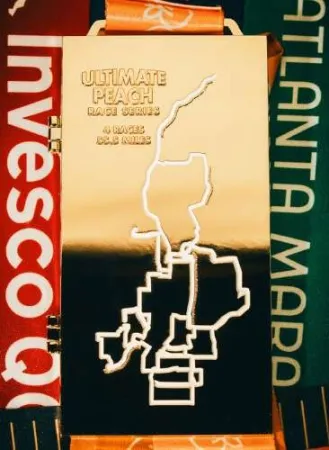 Gold Ultimate Peach Race Series medal with race map design and orange ribbon shown open and closed in close-up.