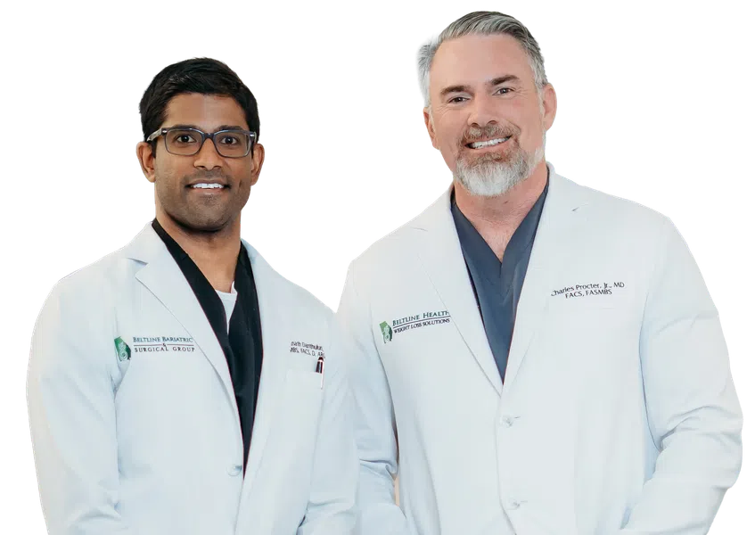Two male doctors in white coats smiling, one with glasses and dark hair, the other with gray hair and beard.