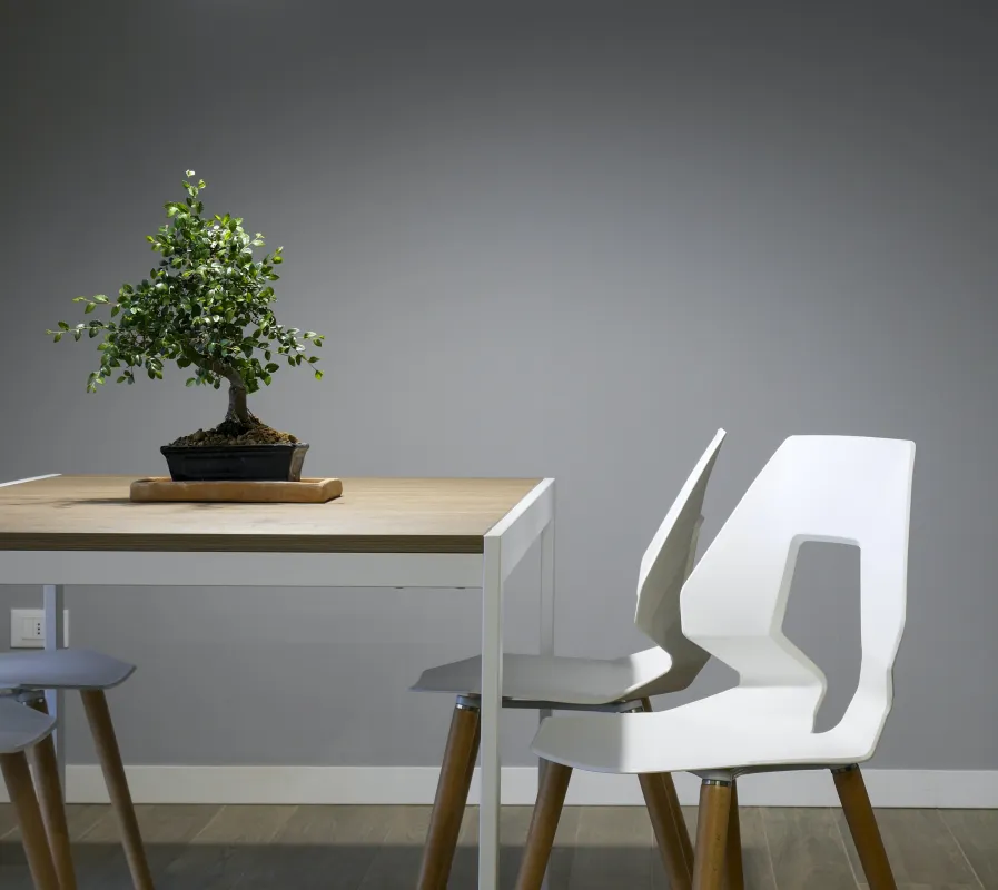 a chair sitting in front of a wooden table