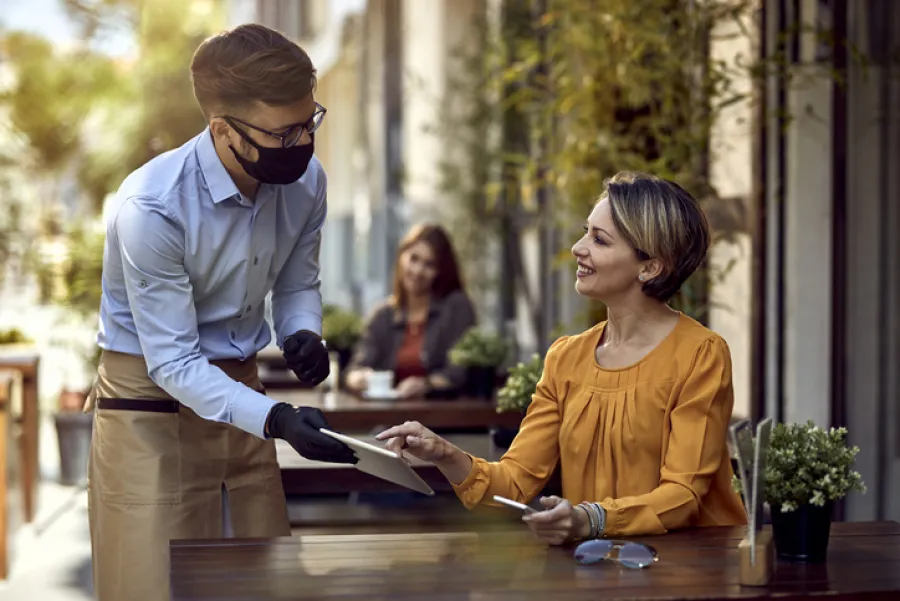 a couple of people standing around a table