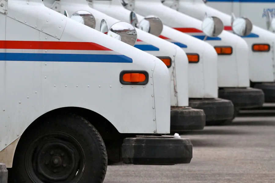 A fleet of postal service trucks